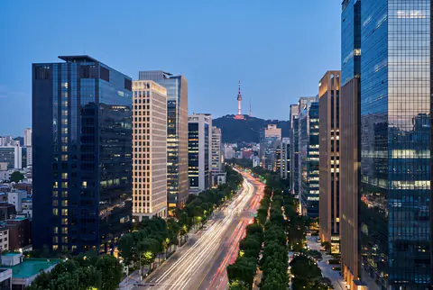 Seoul business district at dusk with N Seoul Tower in the distance